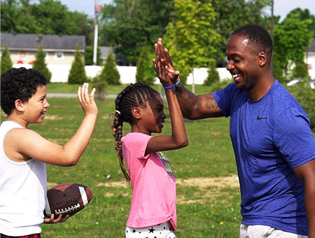 CIS Site Coordinator High Fiving Students