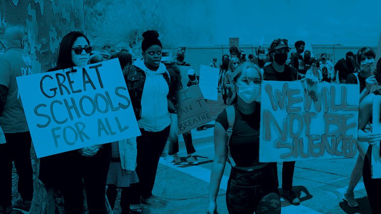 Protestors carrying signs that say "Great schools for all" and "We will not be silenced"