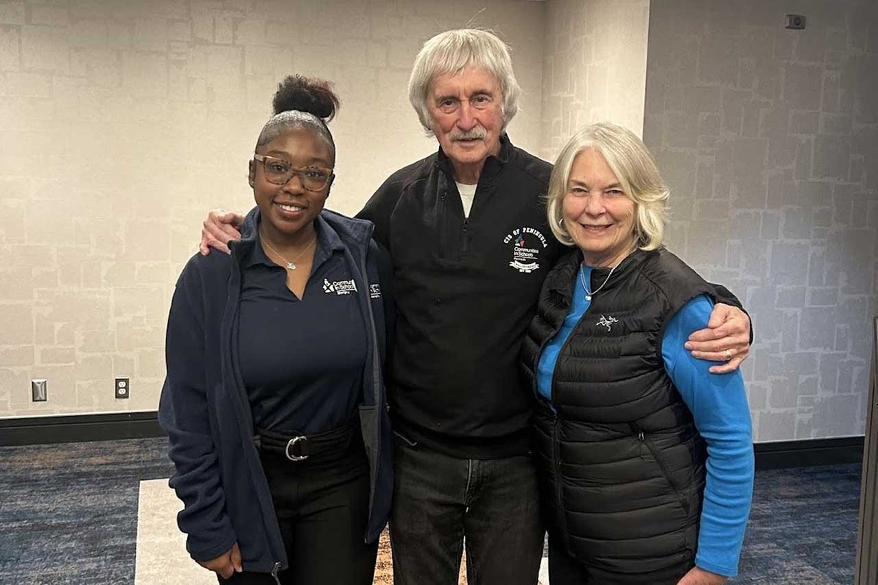 CIS Founder Bill Milliken poses with his wife Jean and CIS Alum Kai